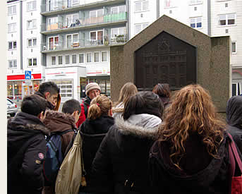 Jugendliche vor dem Gedenkstein für die in der Reichspogromnacht 1938 zerstörte Synagoge in der Essenweinstraße